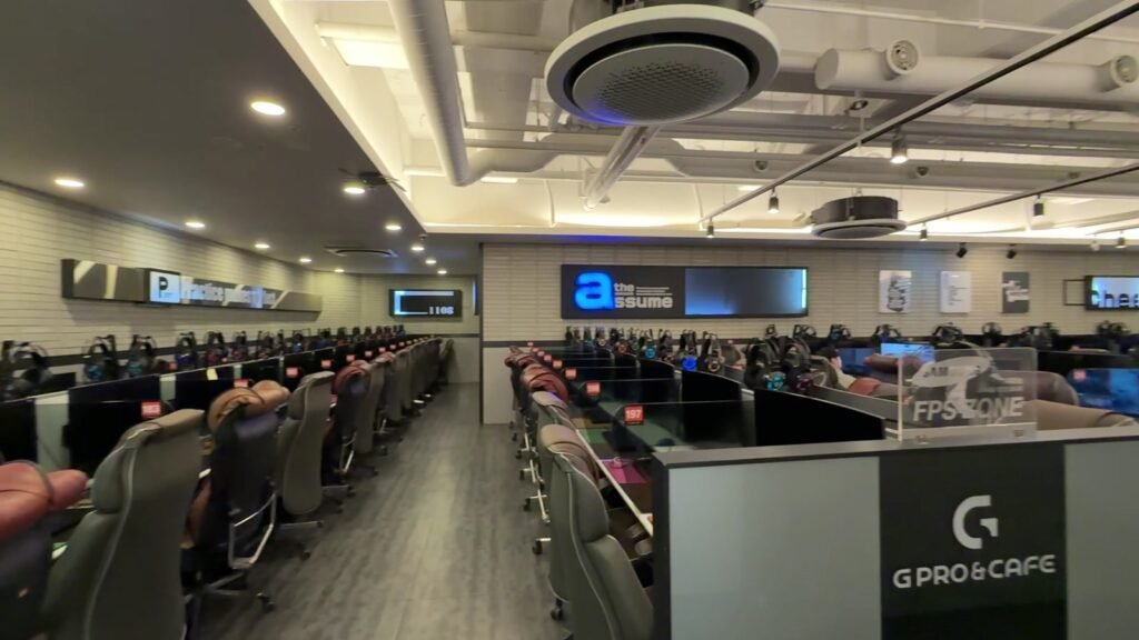 Rows of gaming computers, headsets and chairs inside a PC bang in Seoul